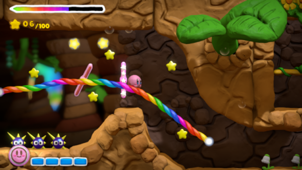 Screenshot: Kirby gleitet an der Regenbogenschnur (buntes Seil) entlang