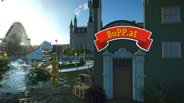 Screenshot: Auf einem Haus steht BuPP.at geschrieben. Im Hintergrund sind ein Märchenschloss und Fahrgeschäfte zu sehen.