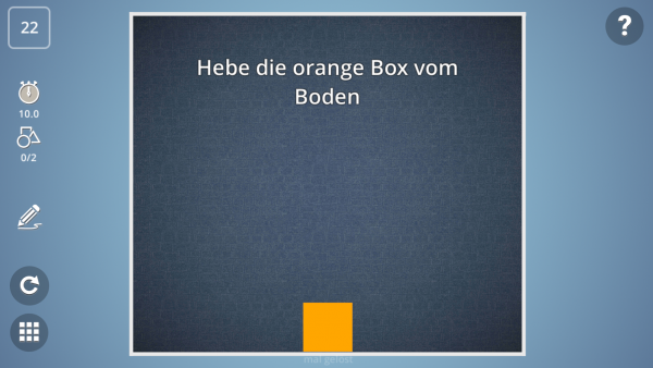 Screenshot: Eine orangerne Box in einem Raum mit der Spielanweisung "Heb die orangene Box vom Boden". 