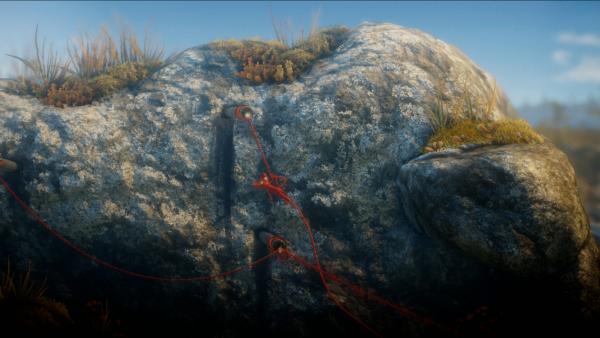 Screenshot: Yarny schwingt an einem Rohr, das aus einem Felsen ragt